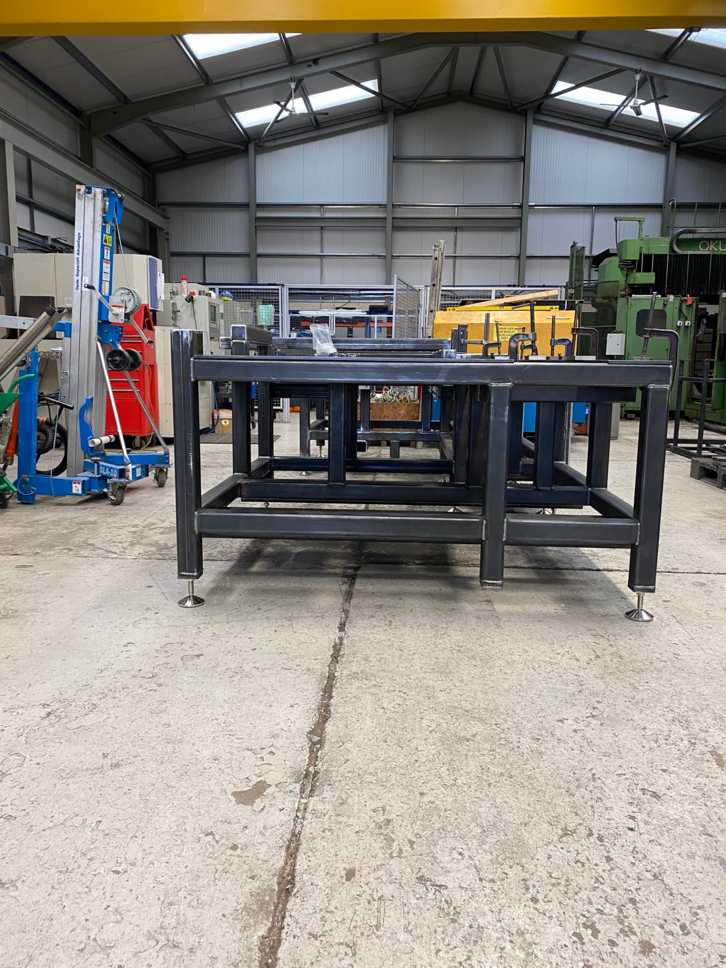 Fabricated steel machine base for the automated drilling and punching system