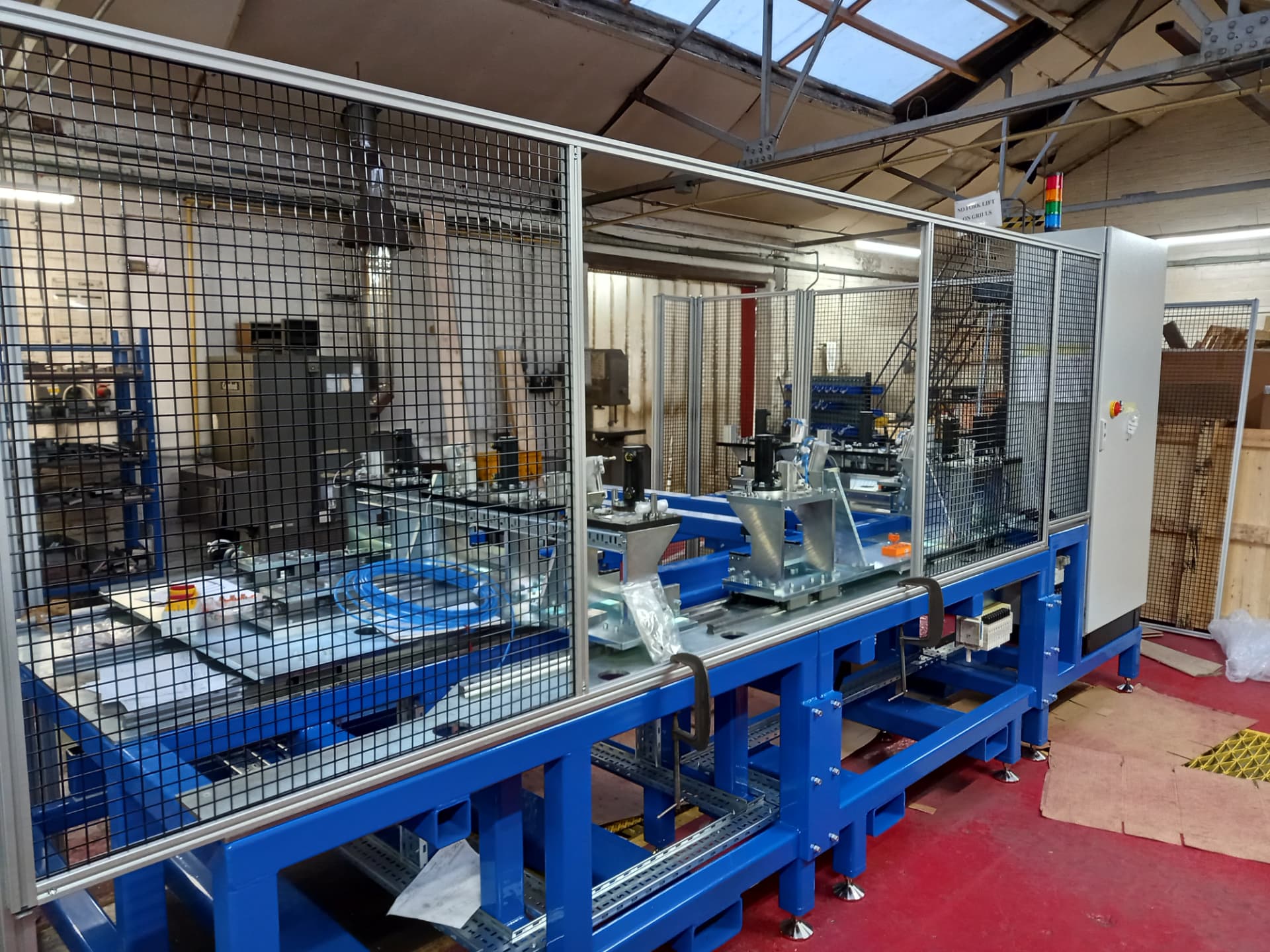 Guarded automated drilling and punching machine with adjustable fixture arrangement
