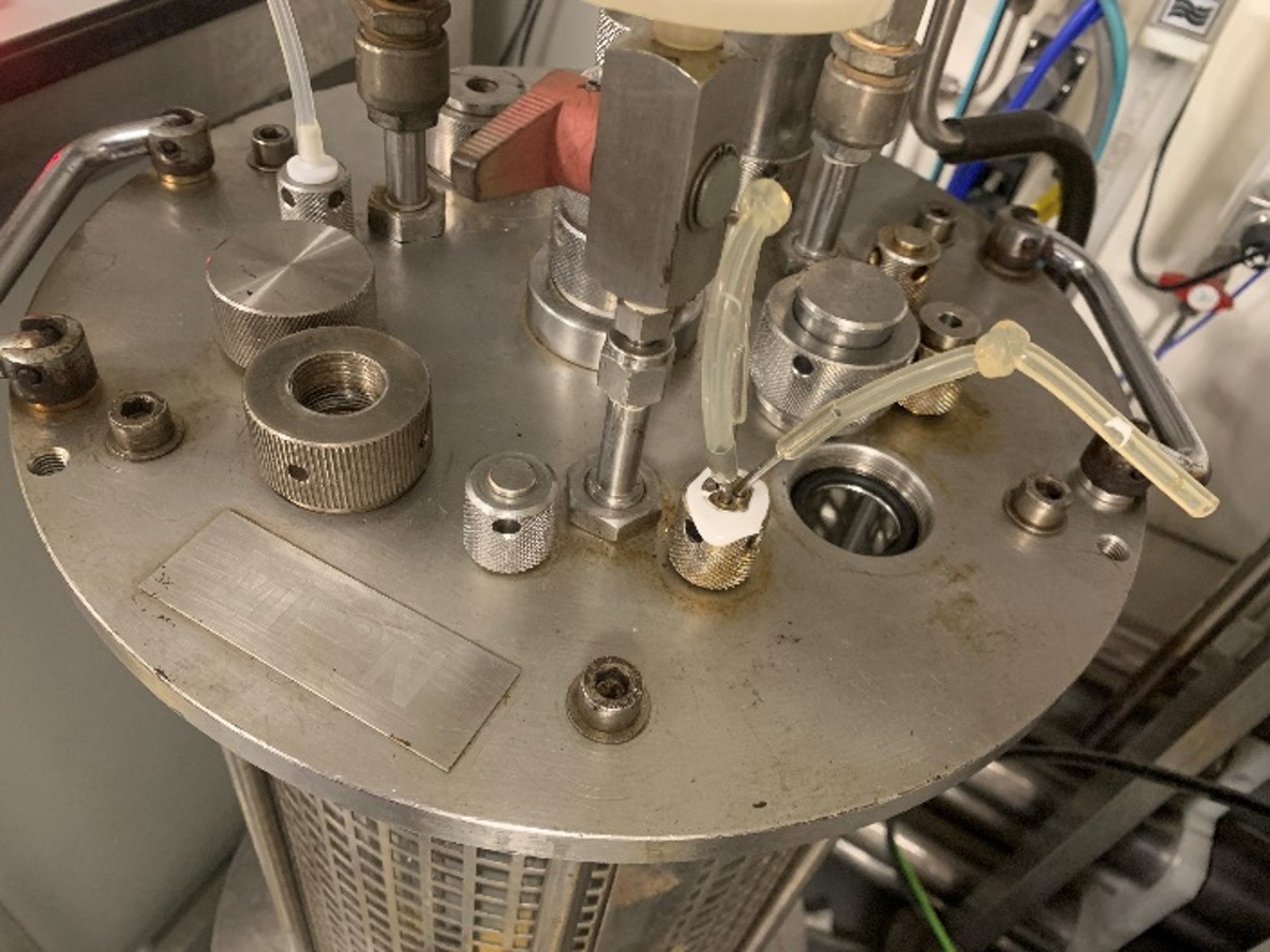 Close-up of the bioreactor vessel showing mechanical connections and process fittings