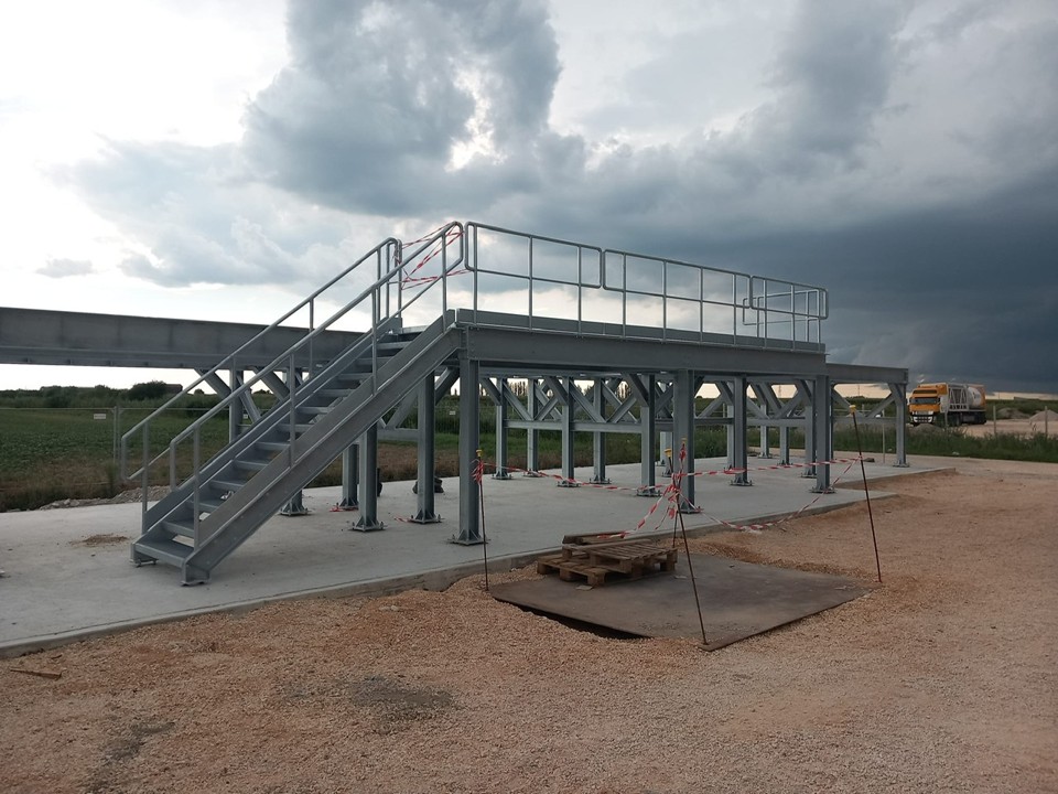 Completed modular steel support platform with access stairs and handrails